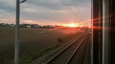 Das Bild zeigt einen Sonnenuntergang auf der Rückreise aus dem Zug fotografiert.